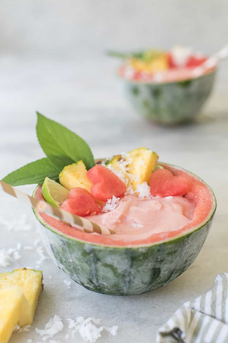 watermelon bowl with a tropical cocktail served inside. 