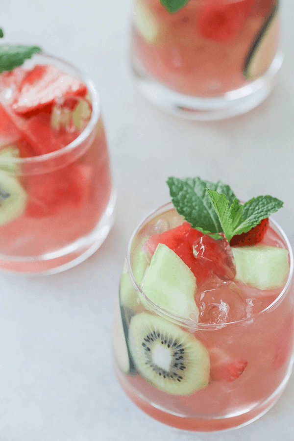 Watermelon Sangria in a glass with chunks of fruit. 