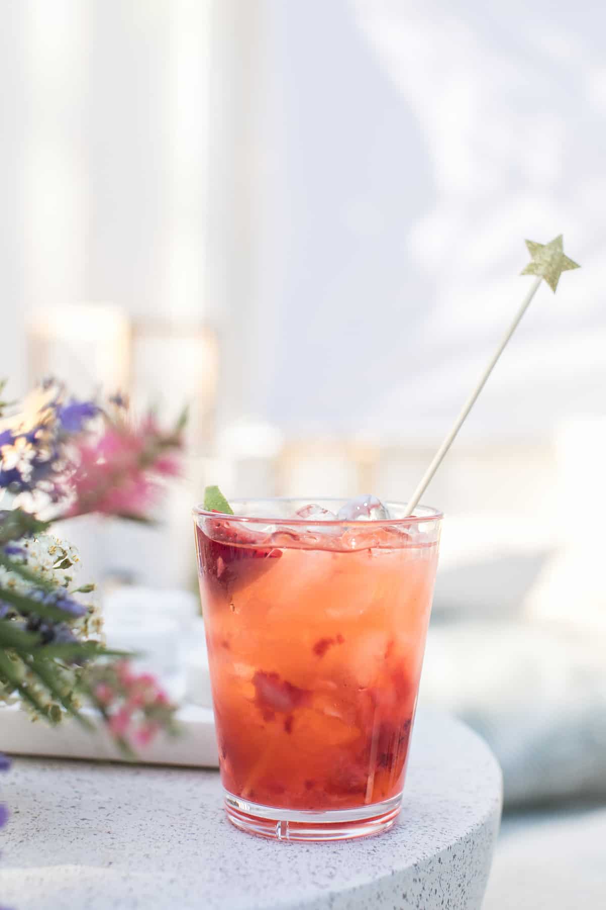 Strawberry soda with star stir stick.