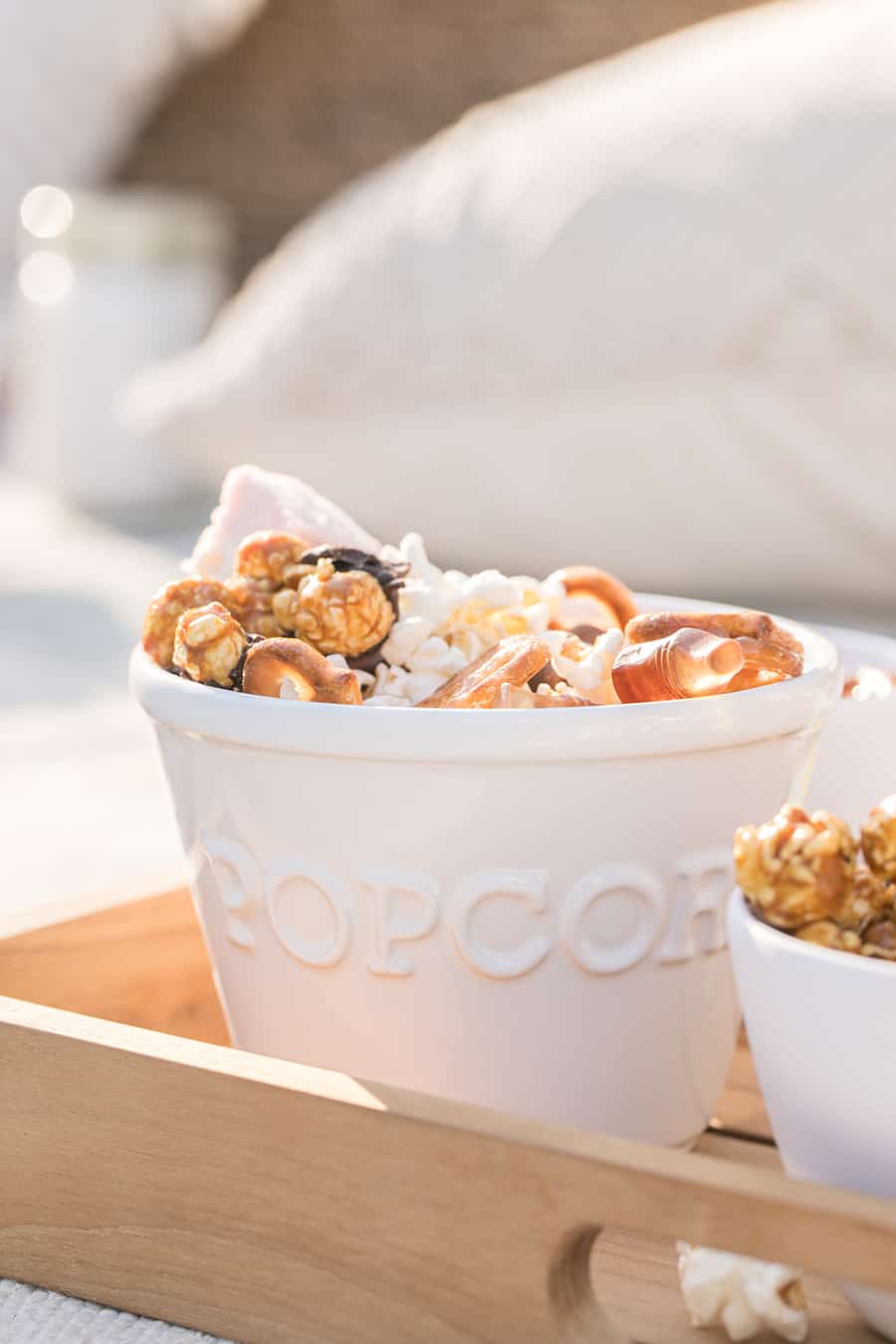 Popcorn bowl with popcorn with chocolate and pretzels.