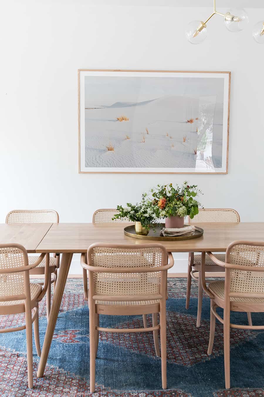 Dining room with blue rug.