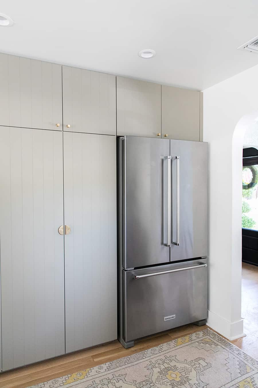 Kitchen Aid refrigerator with green cabinets from Ikea and Semihandmade.