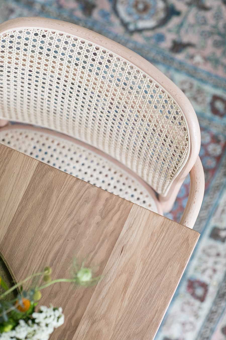 Dining room table, blue rug and dining chair.