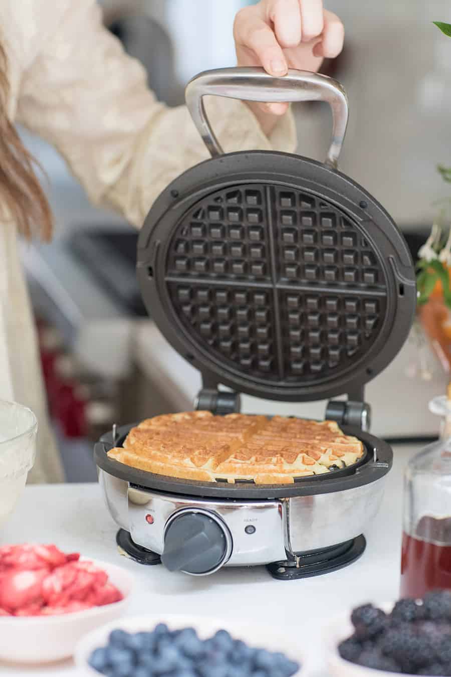 A homemade waffle inside a waffle maker. 