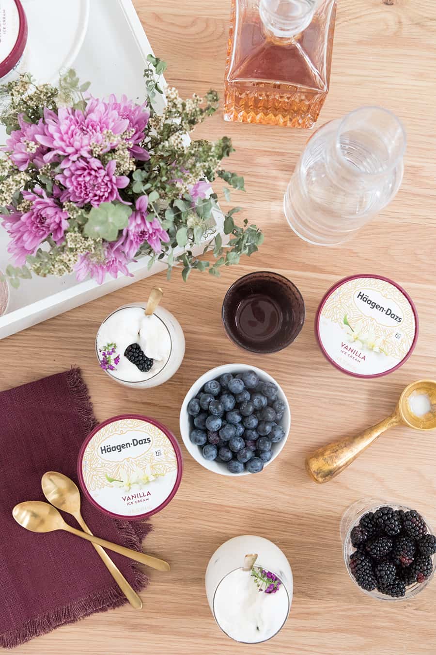 over head of ice cream and berries to make boozy ice cream floats