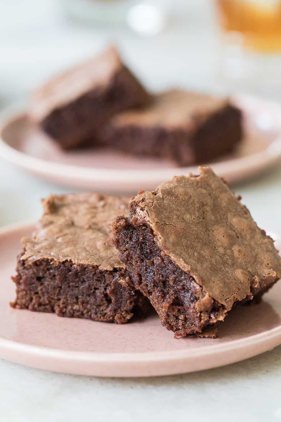 Chocolate brownies on a pink plate. - bourbon brownies