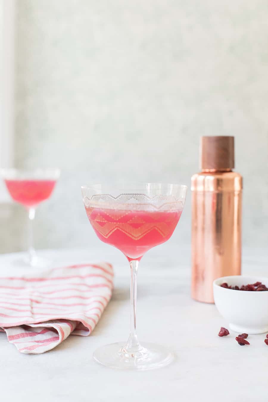 Pink drink in a coupe glass.