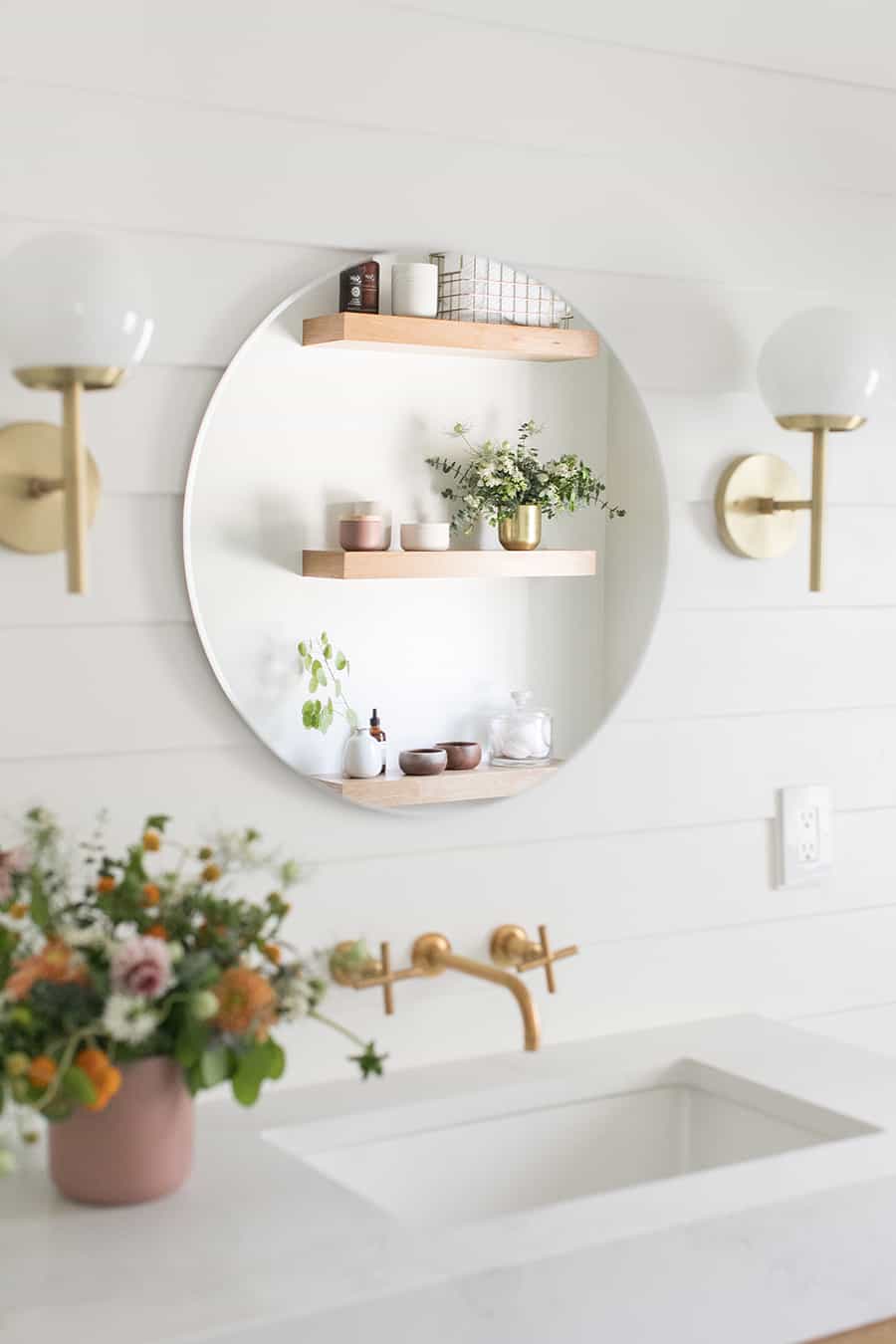 Modern and Charming bathroom with gold mirror.