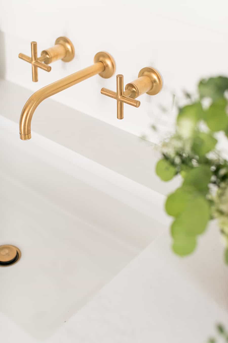 Gold Kohler facet in modern bathroom