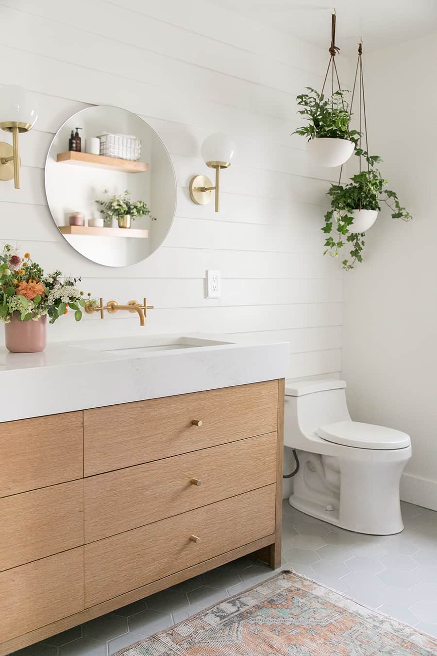 Modern, charming bathroom with hanging plants and wooden vanity. - double vanity