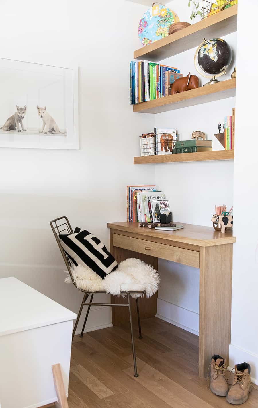 built in desk with shelves filled with books.