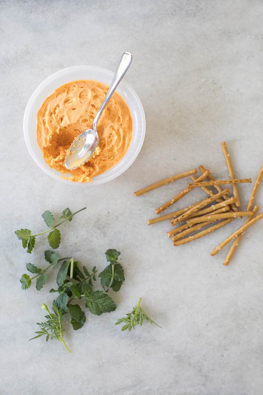 Pub cheese with pretzel sticks and herbs,