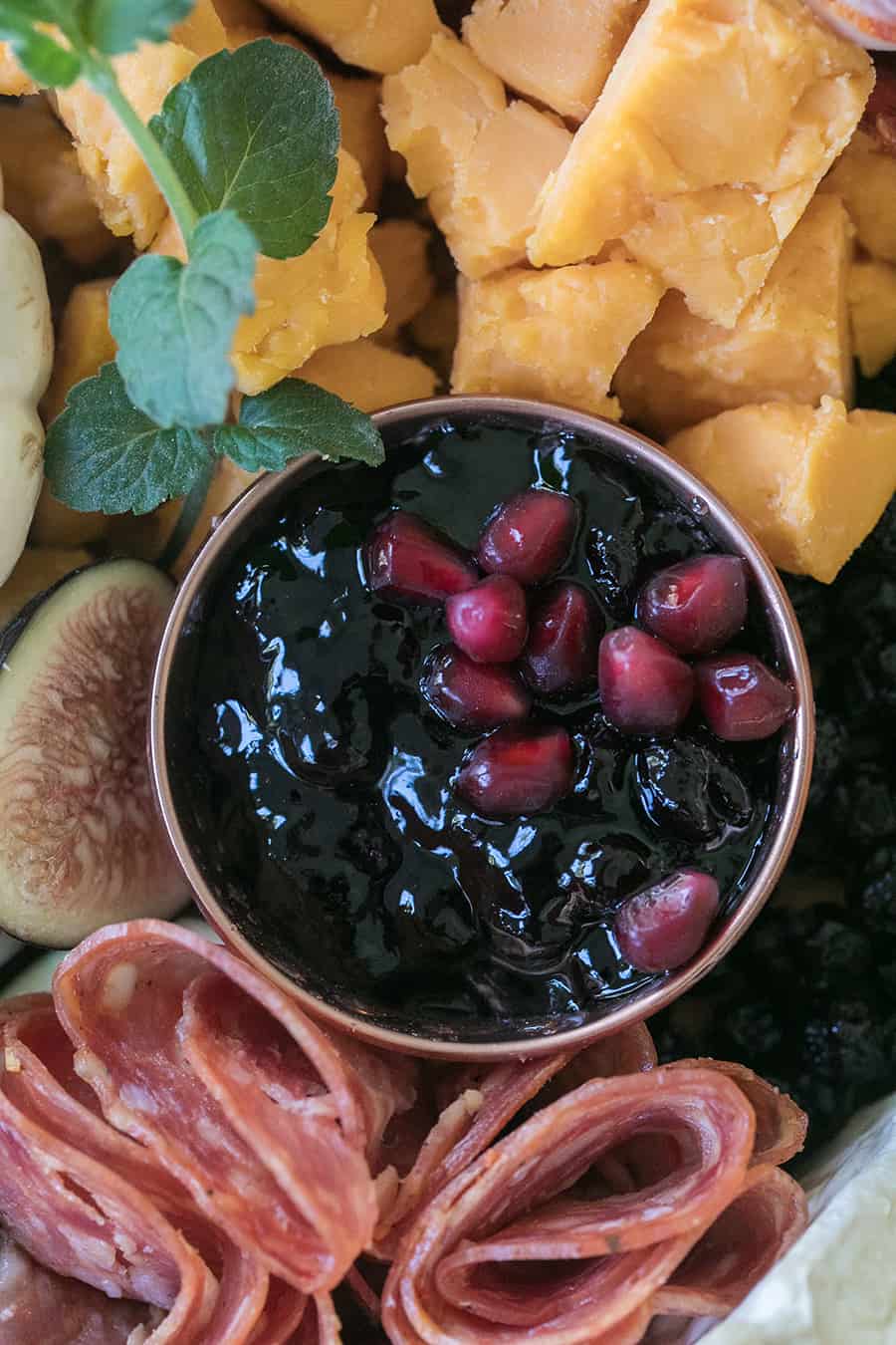 Pomegranate jam in copper bowl.