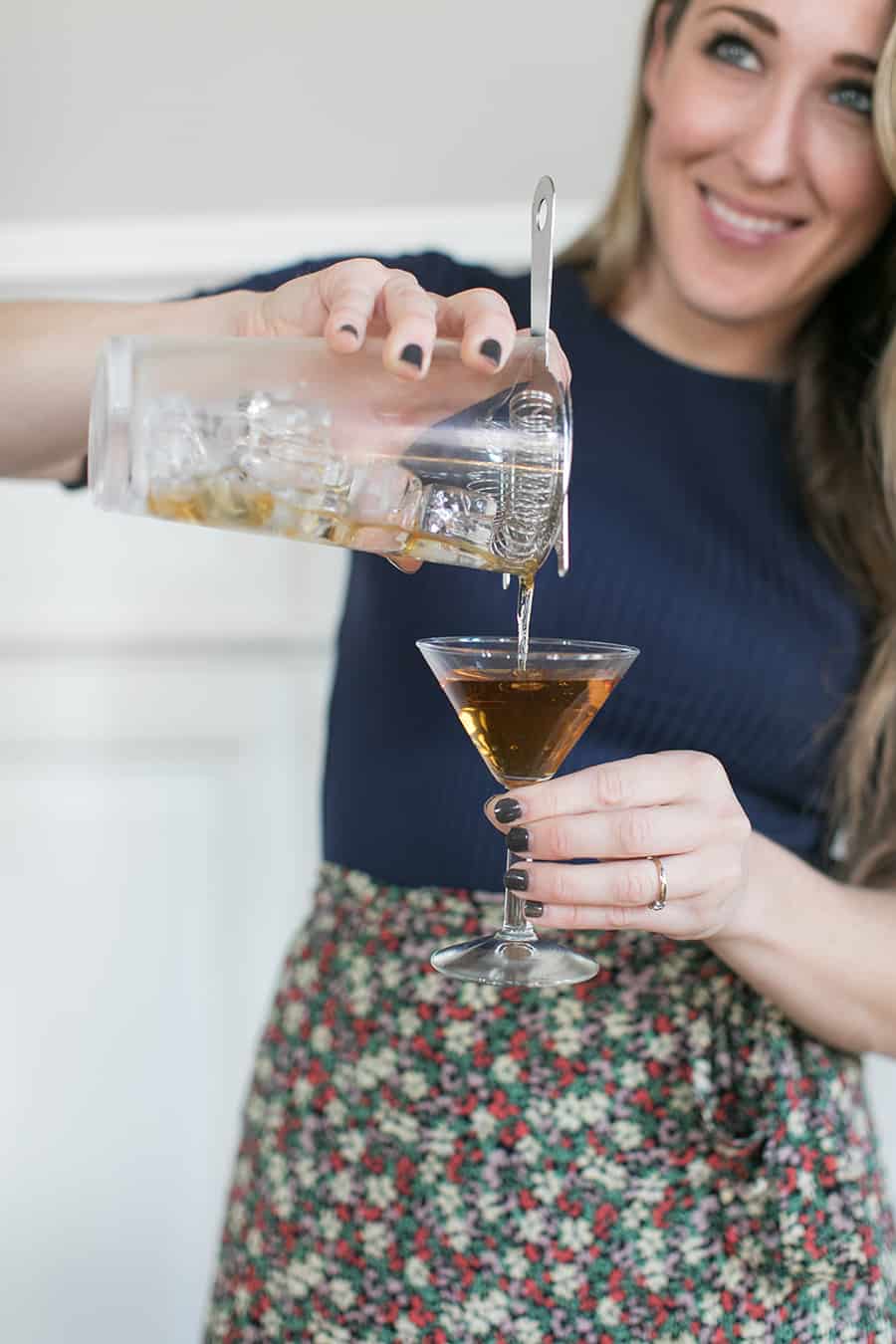 Eden Passante pouring Bénédictine cocktail into a glass.