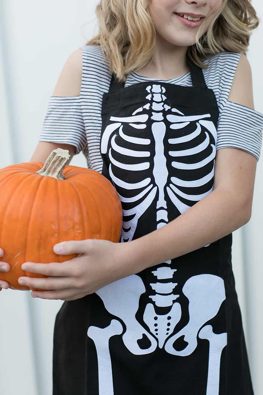 shot of child holding a pumpkin