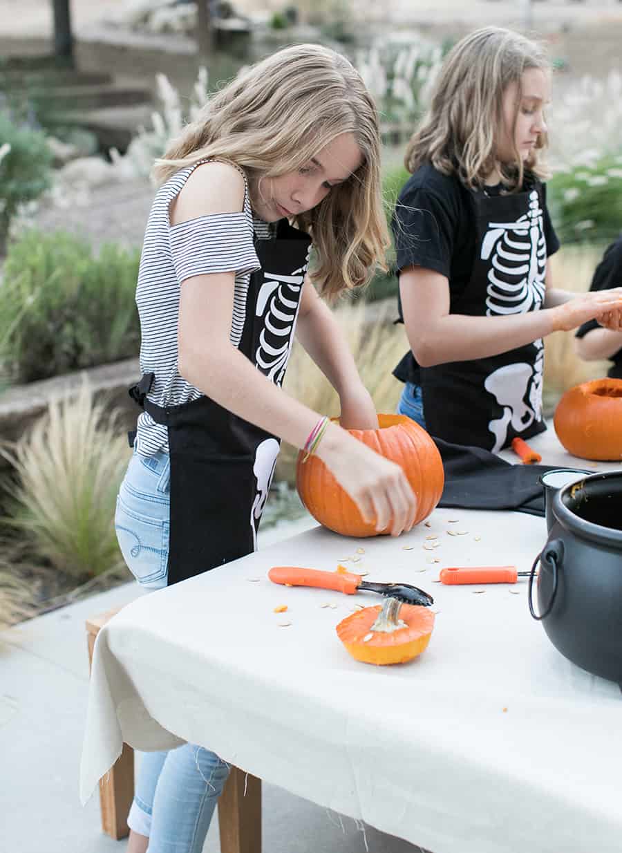 girl carving a pumpkin 