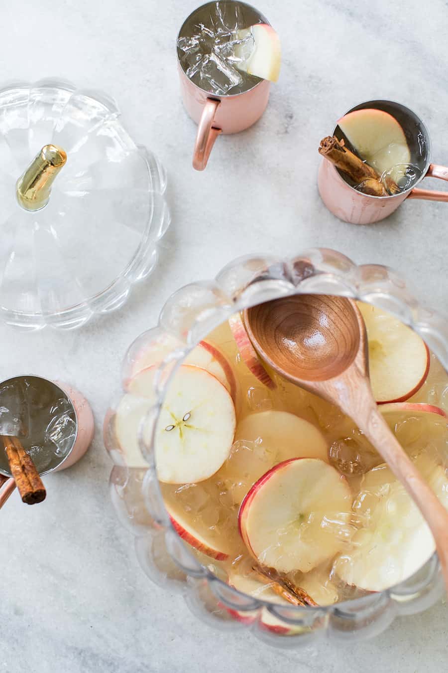 top down shot of table with punch bowl containing apple cider punch