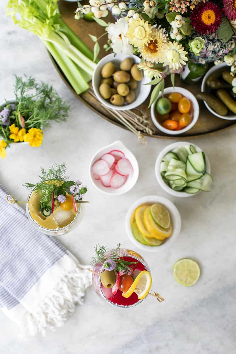 Overhead photo of a bloody Mary bar on a marble table