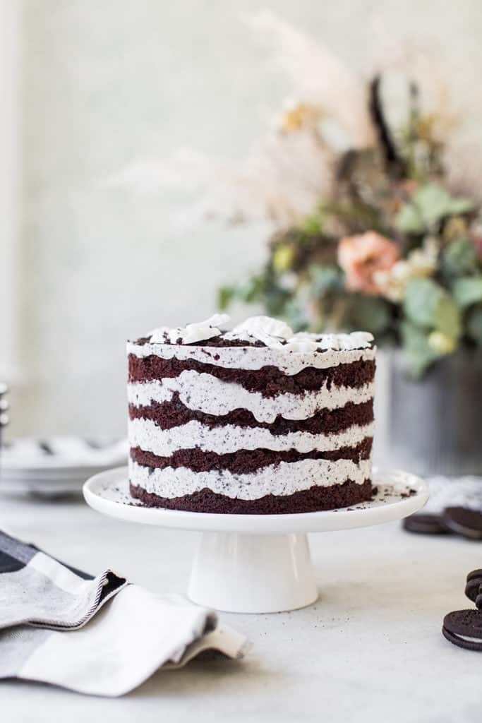 White chocolate layered cake on cake stand.