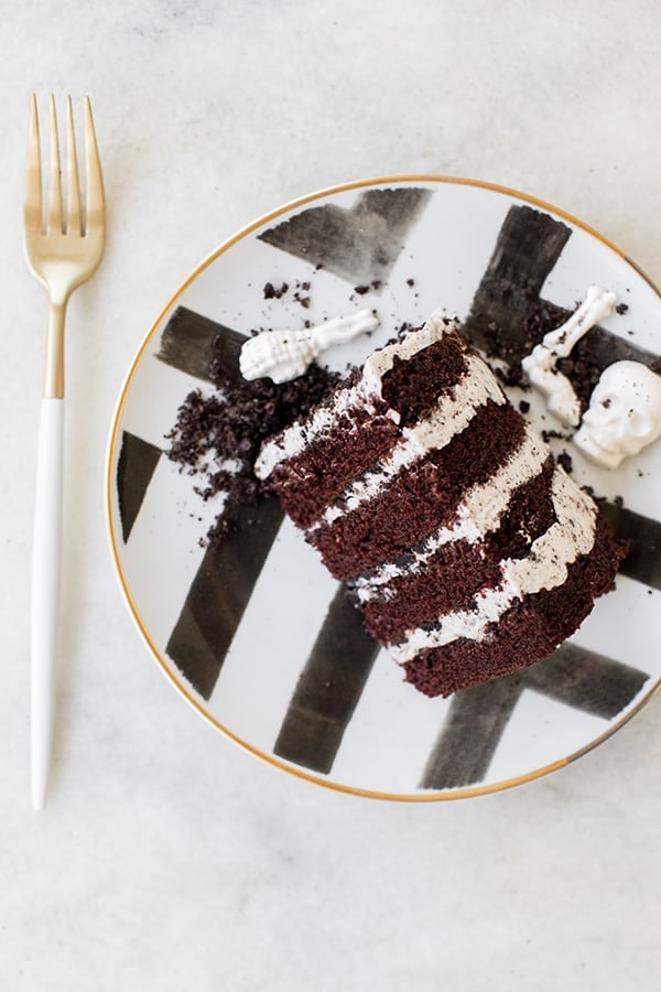 Layered chocolate and vanilla cake on a a black and white plate.