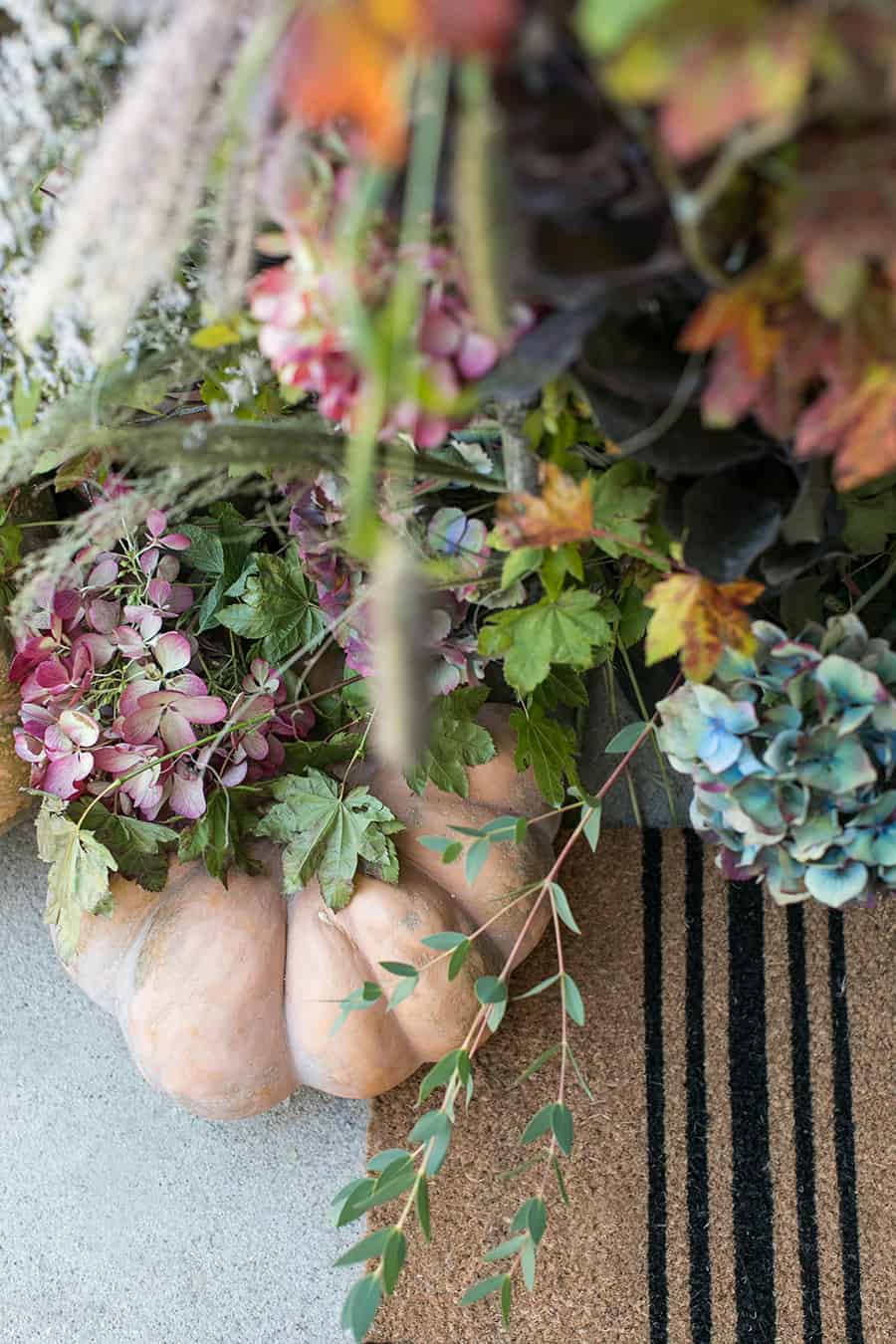 flowers and pumpkins on front porch 