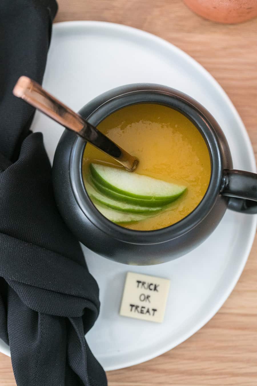 overhead shot of curried butternut squash soup in a mini cauldron