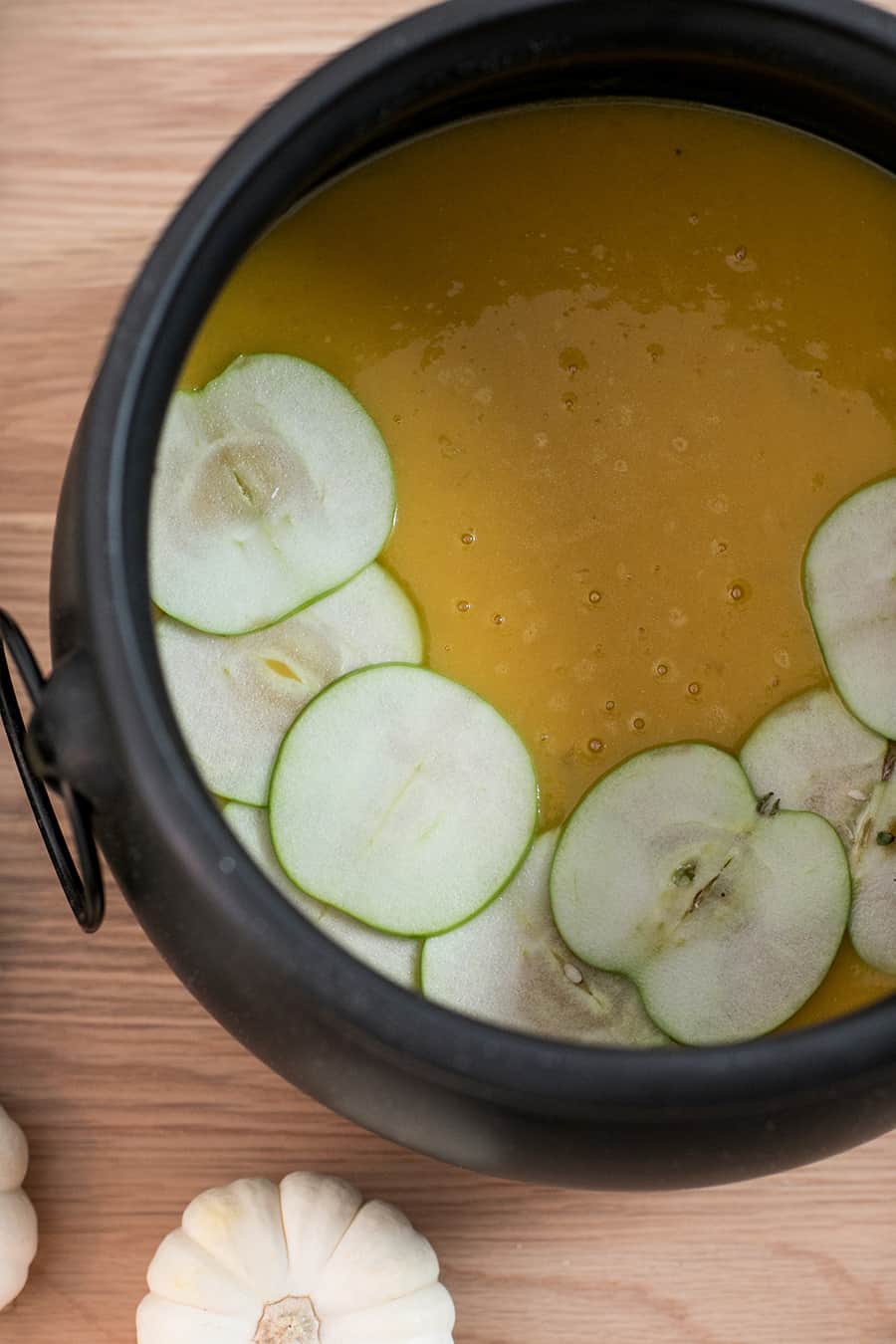 top down shot of curried butternut squash soup in a cauldron