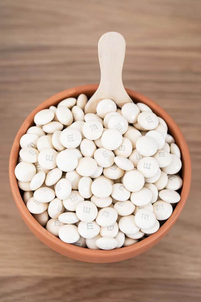 White m&ms in a terra cotta pot.