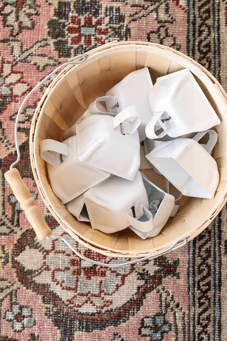 cowbells in a wooden basket 