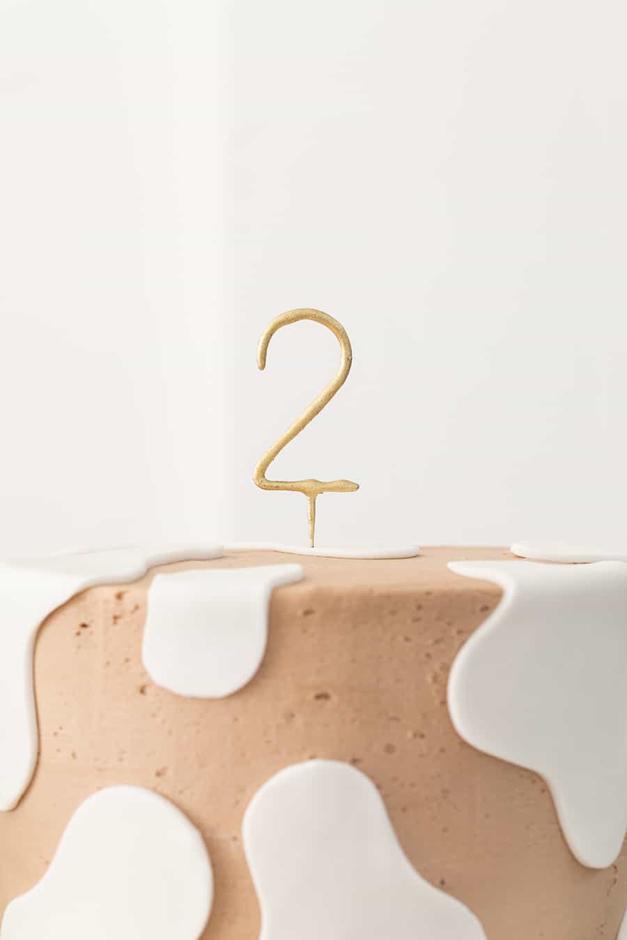 cow cake with number 2 sparkler for a barnyard birthday party