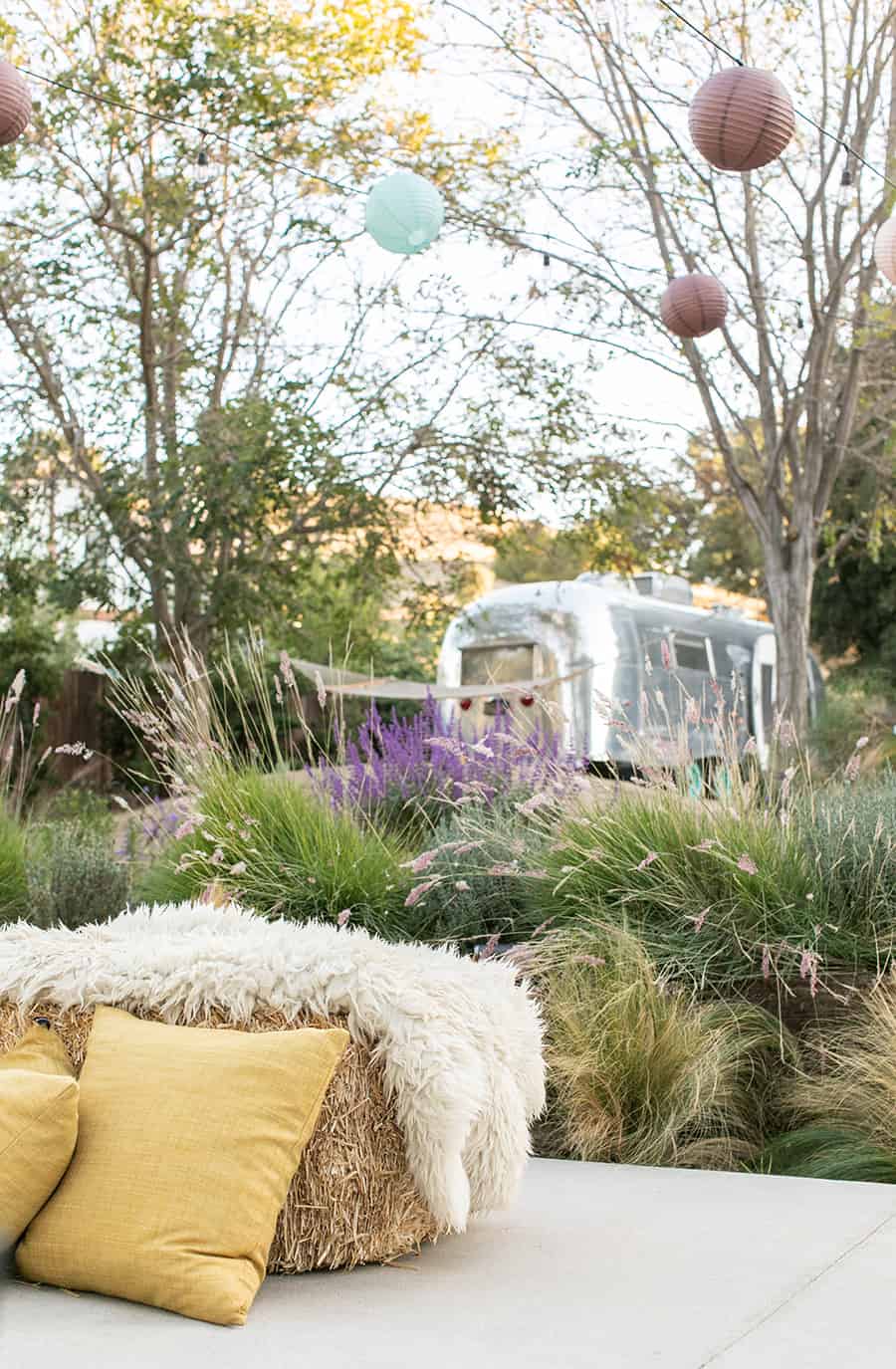 Hay bales  with sheepskin, flowers and a vintage airstream.