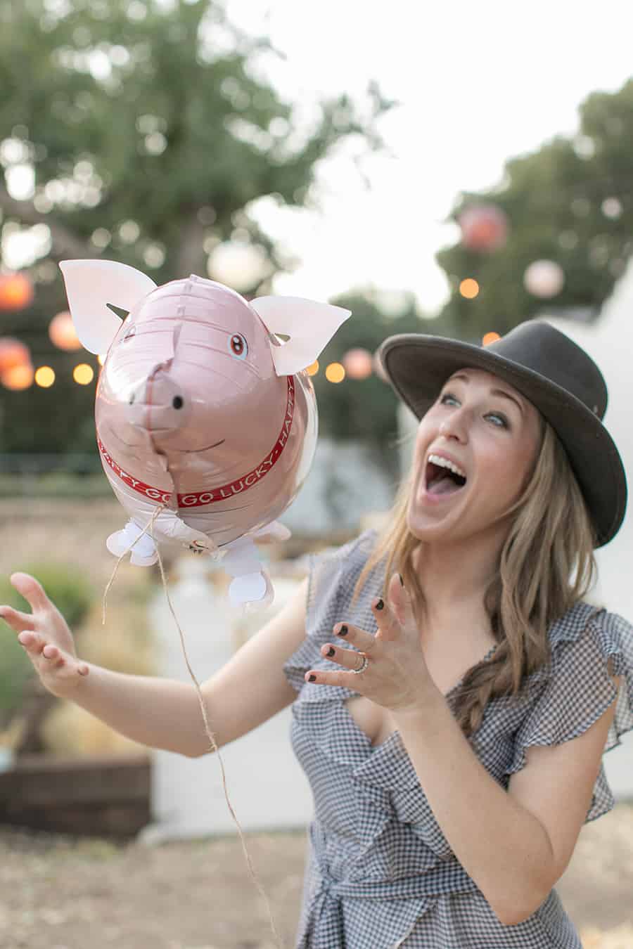 Eden Passante holding pig balloon 