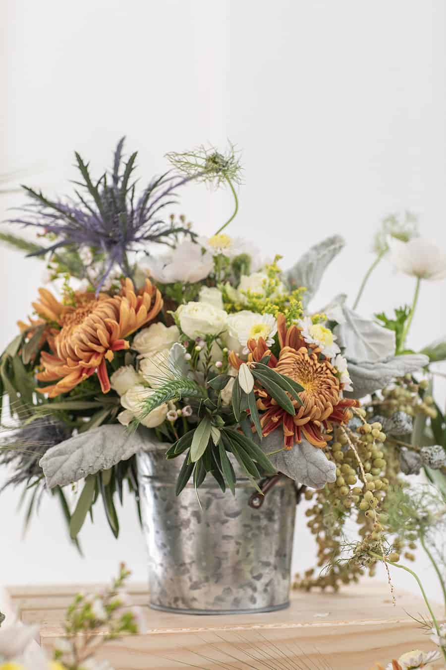 colorful flowers in a galvanized bucket at a barnyard birthday party 