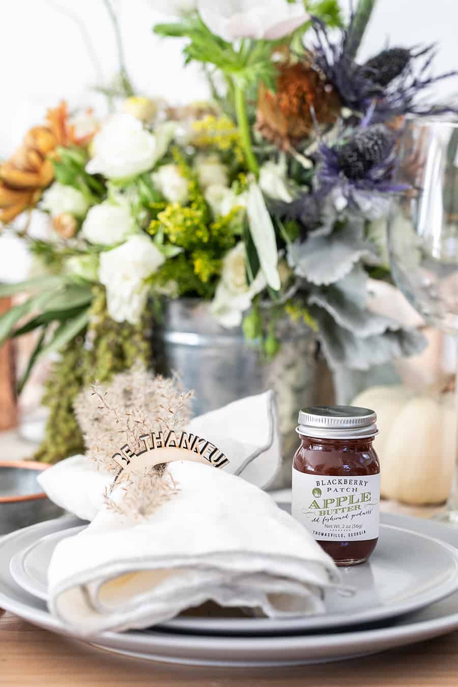 Be Thankful napkin rings and a jar of apple butter on a Thanksgiving tablescape 