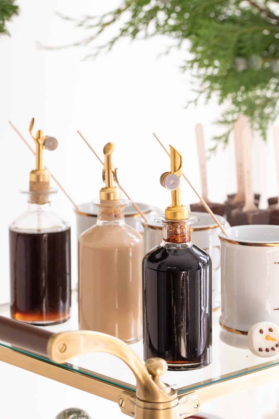 Syrups in glass jars with gold spout 