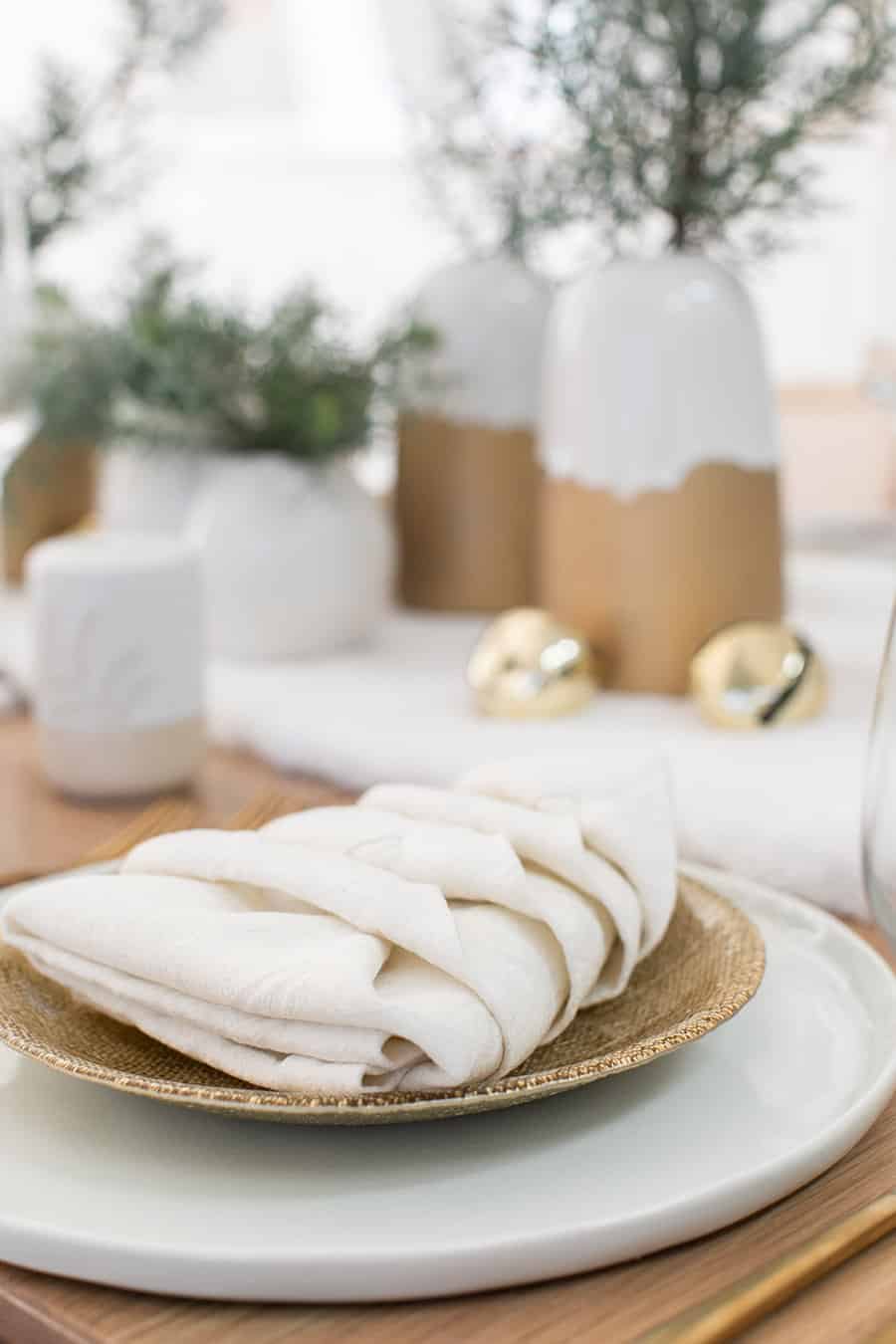 White napkin folded into a Christmas tree for a Christmas Brunch.