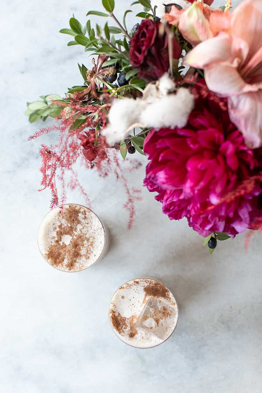 Overhead of Sicilian Kiss with pink flowers on a marble table.