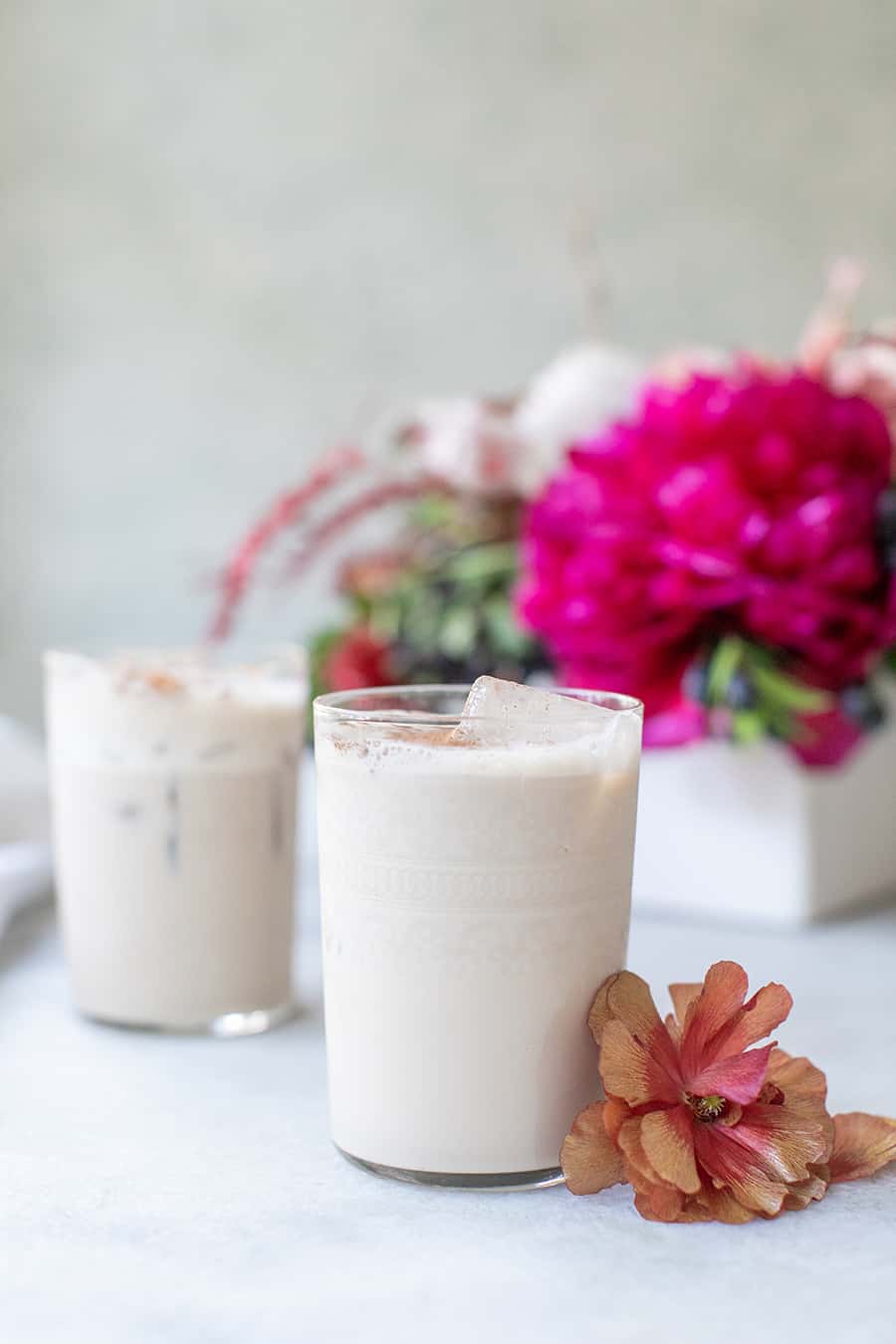 Two Sicilian Kiss cocktail made with Baileys Irish Cream, Kalua, Vodka and cream served in pretty glasses with flowers.