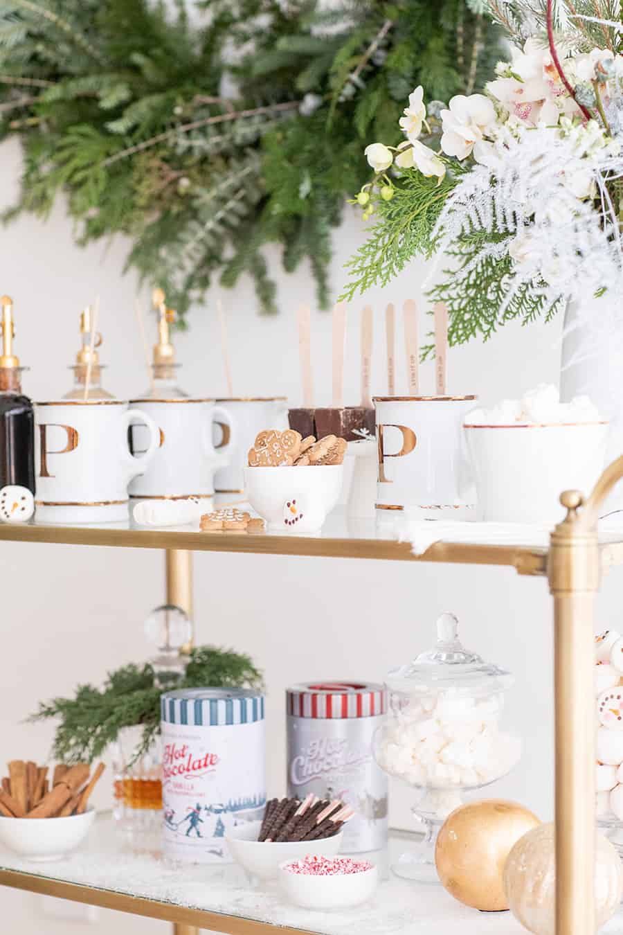 Hot chocolate toppings on a gold bar cart. 