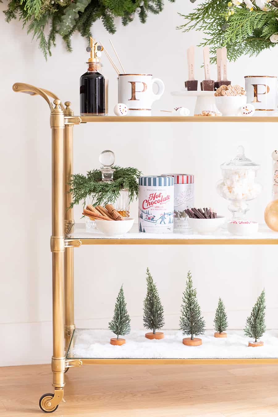 Bar cart with marshmallows, trees faux snow and mugs