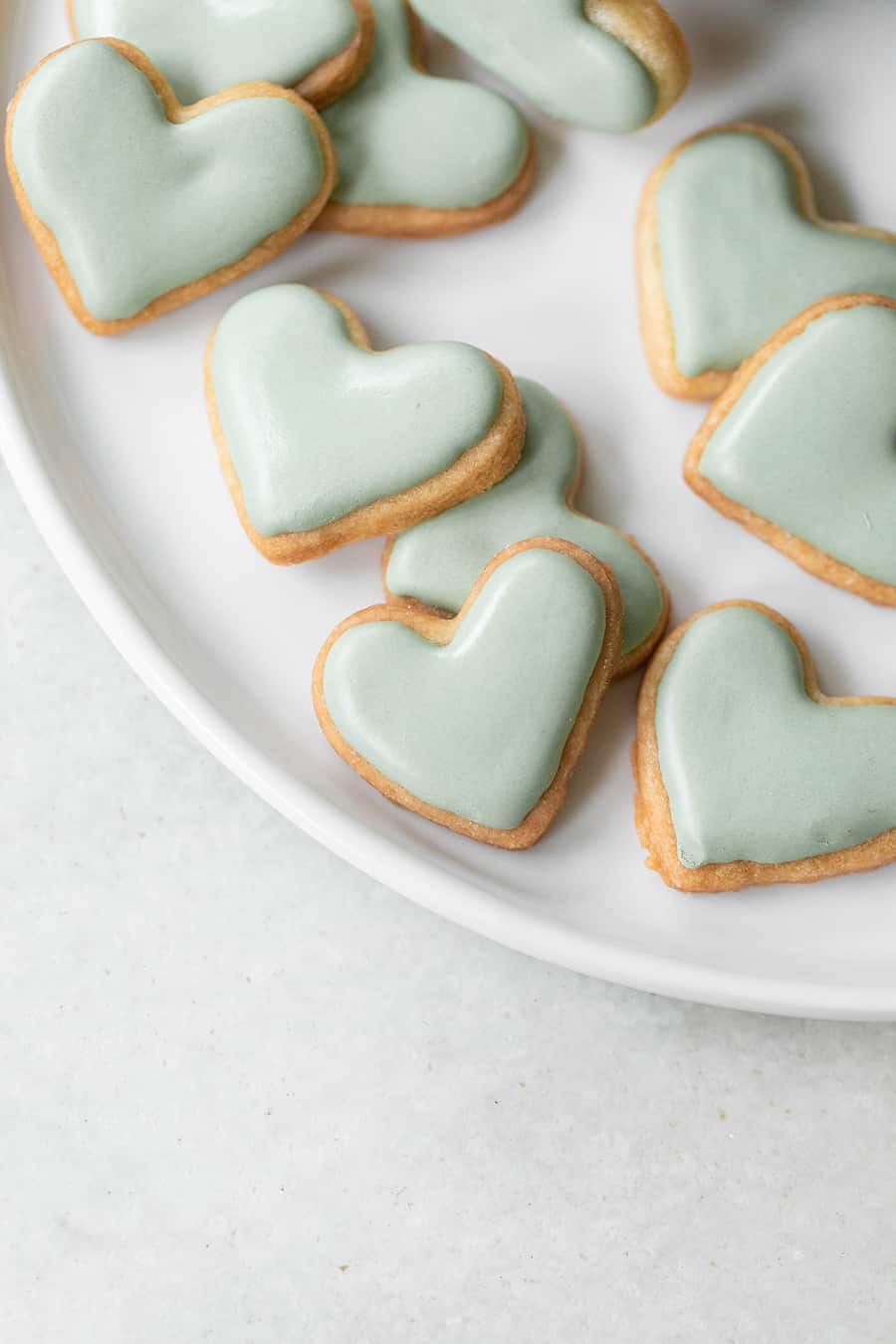 mini blue heart shaped cut out sugar cookies with blue royal icing