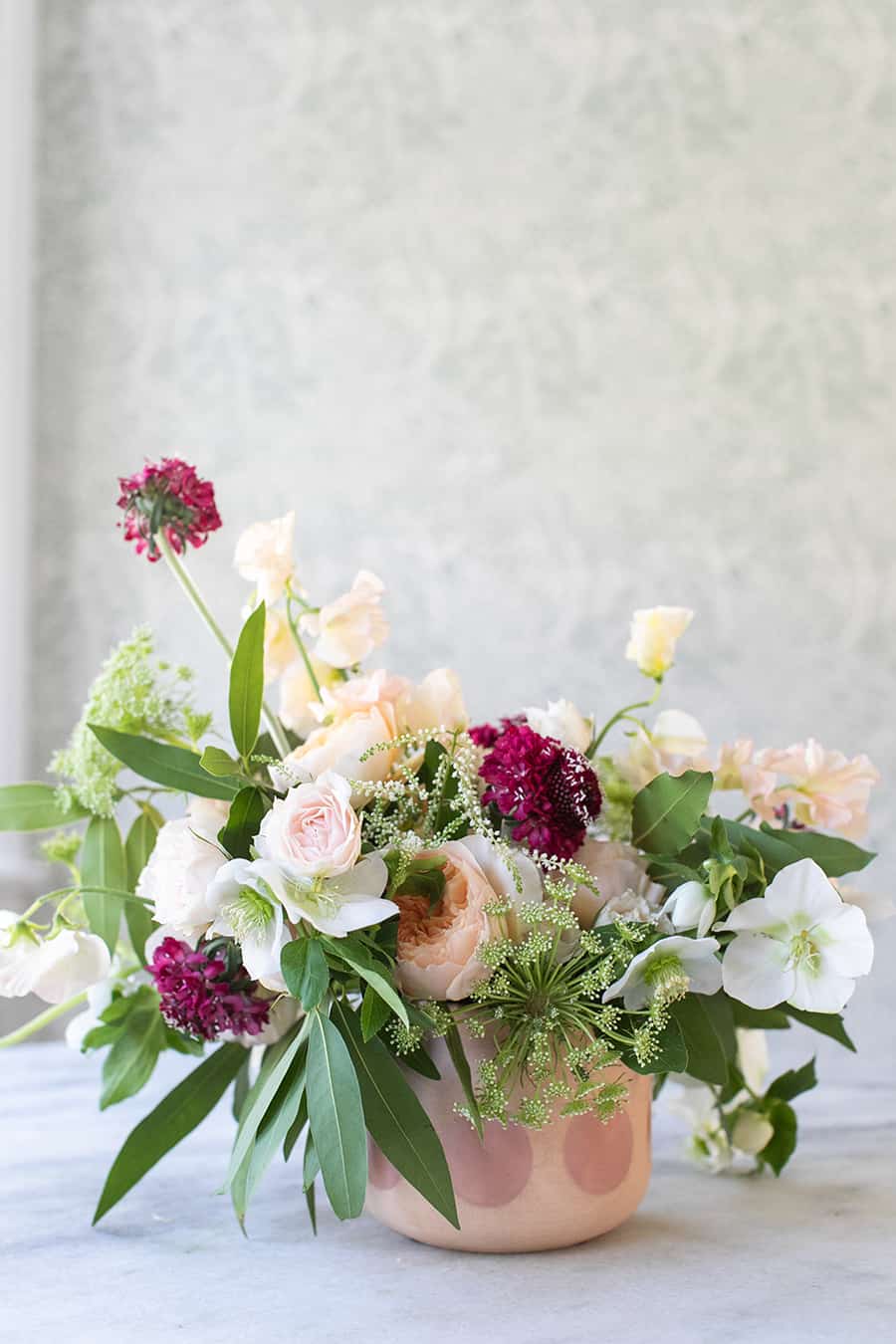 Stunning pink and purple flower arrangement for Valentine's Day in a pink and purple vase.