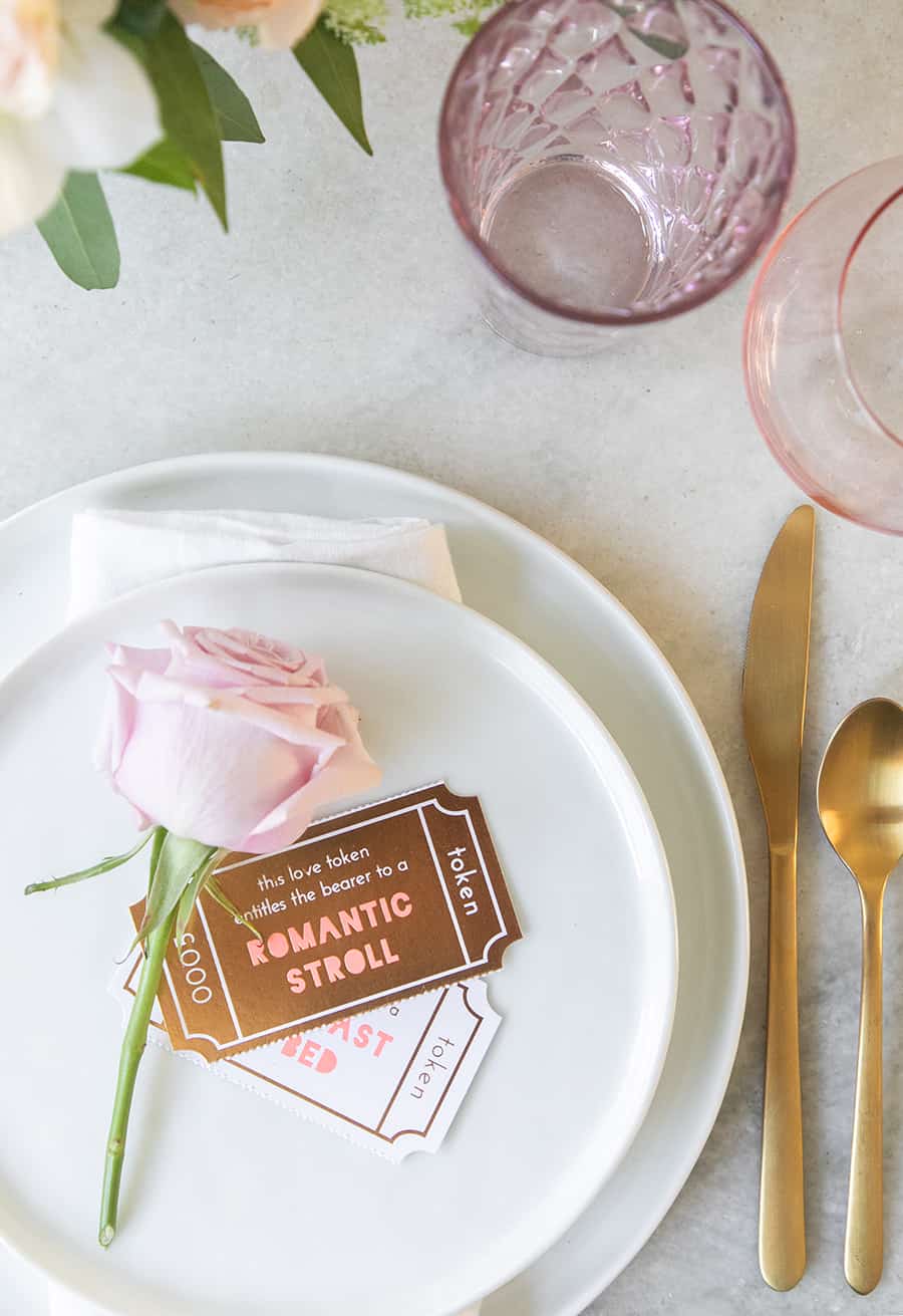 A single rose and token cards for a romantic Valentine's Day dinner.