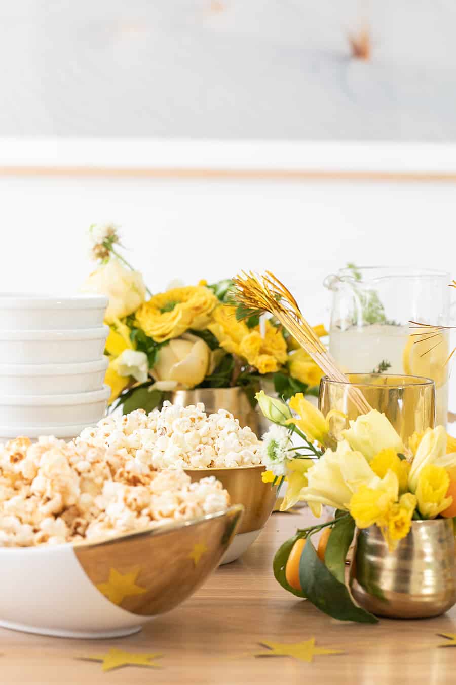 Popcorn in white and gold bowls. 