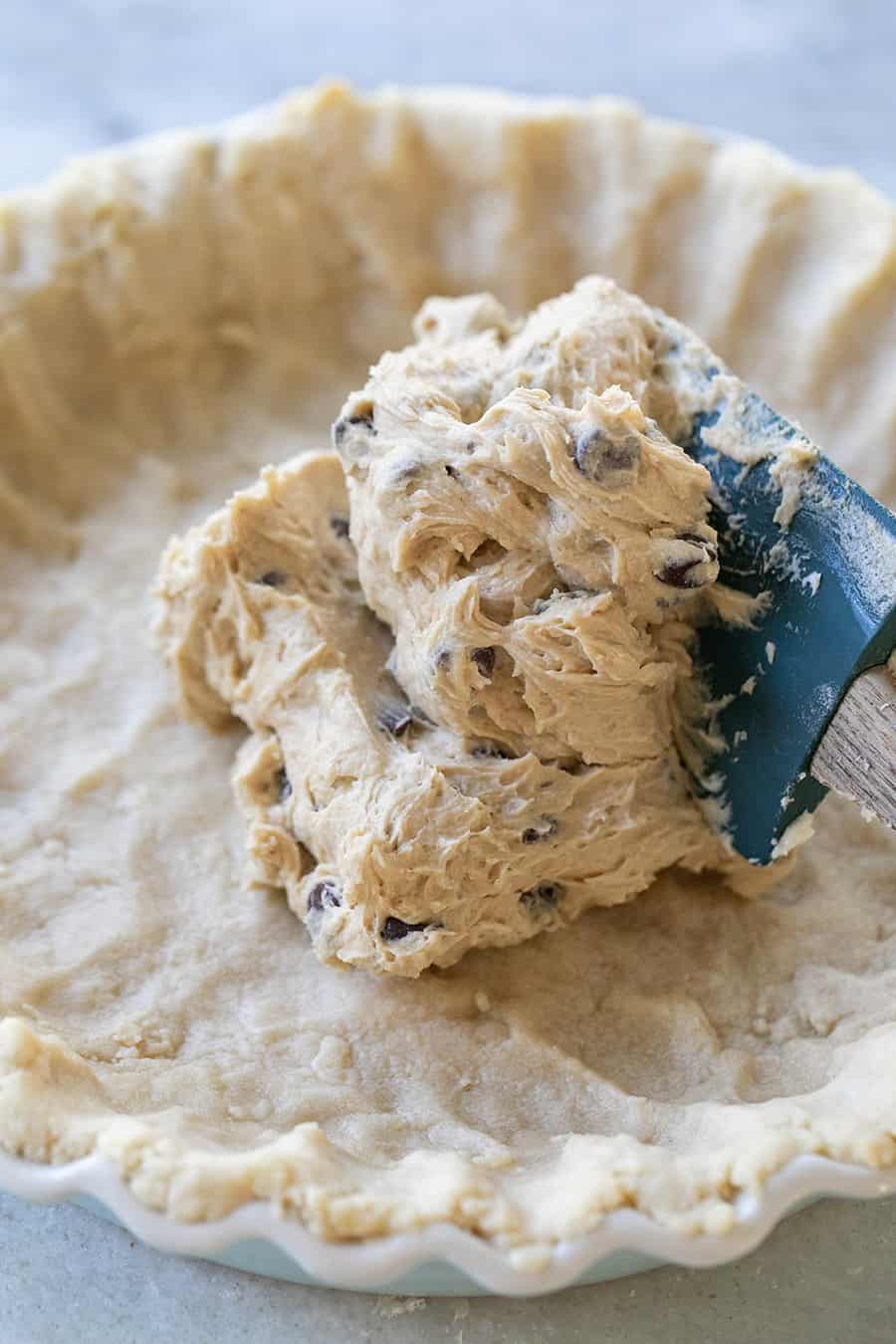 Cookie batter spread into shortbread cookie crust.