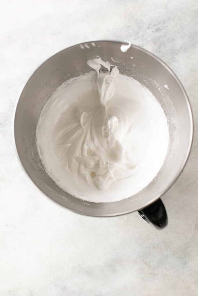 Whipped egg whites and sugar in a bowl.