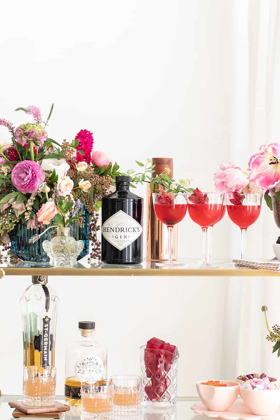 Gin and Flower Bar with cocktails, gin, ice cubes and candy.