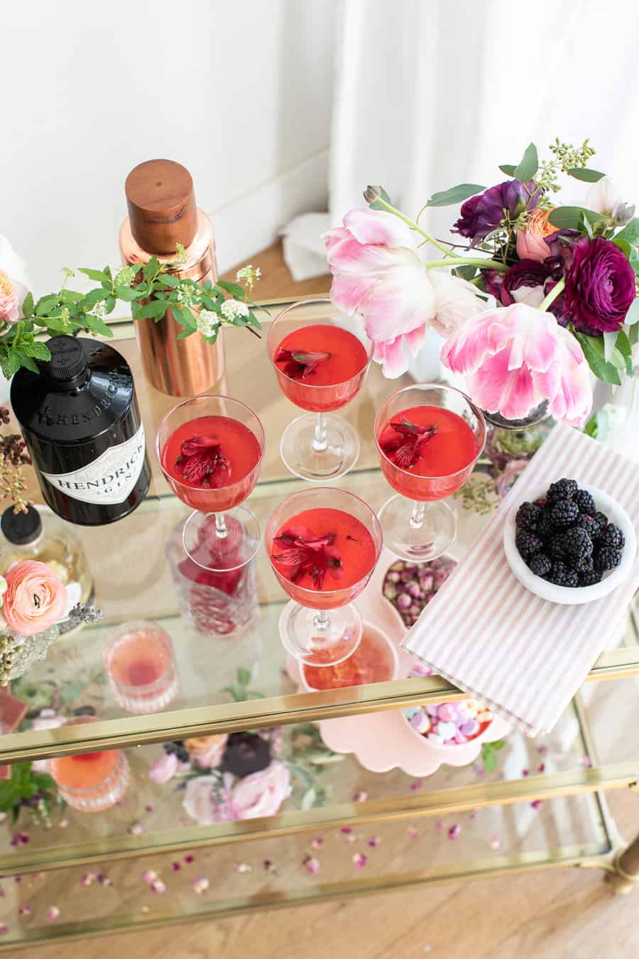 Overhead of a Gin and Flower Bar with cocktails, gin, berries and more. 