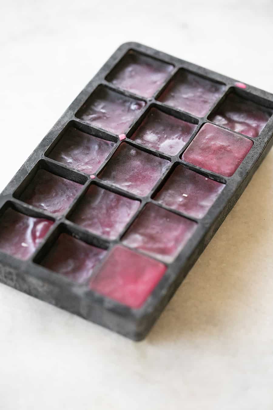 pink ice cubes in an ice cube tray 