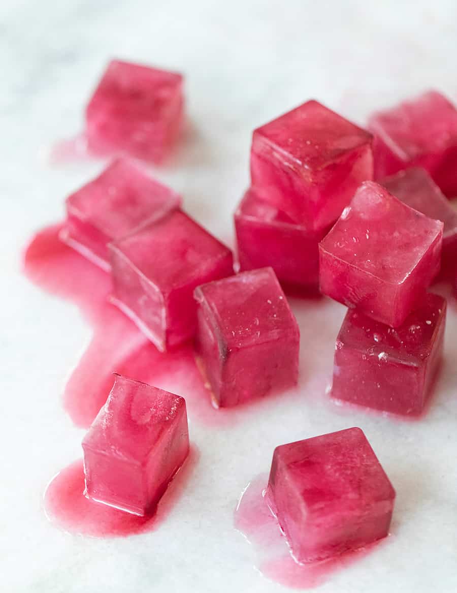 Pink ice cubes melting 